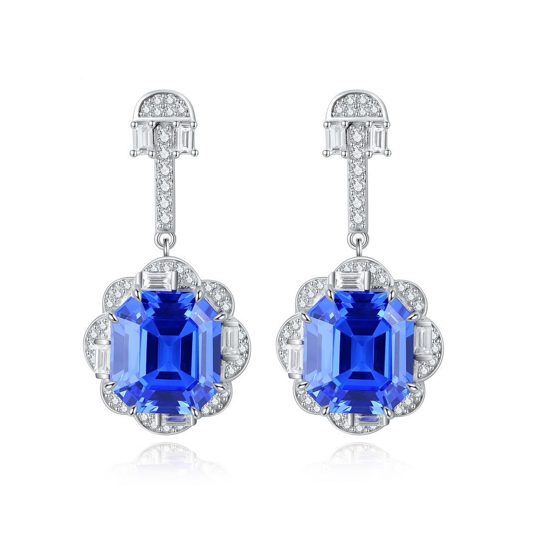 S925 silver earrings, secure clasp. Intricate halo design around a deep - blue lab - grown cobalt spinel, round shape.