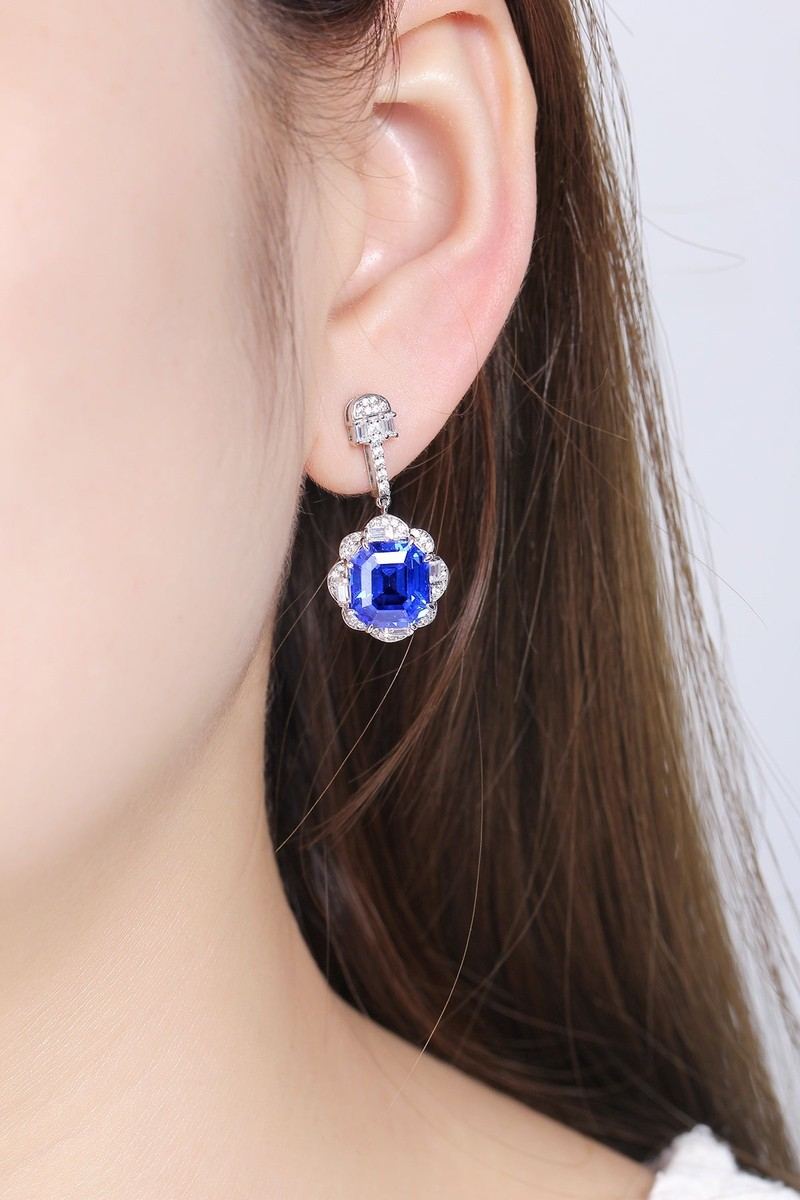 These S925 silver earrings have a fine clasp. Deep - blue gem encircled by diamonds in halo style, vivid color, circular form