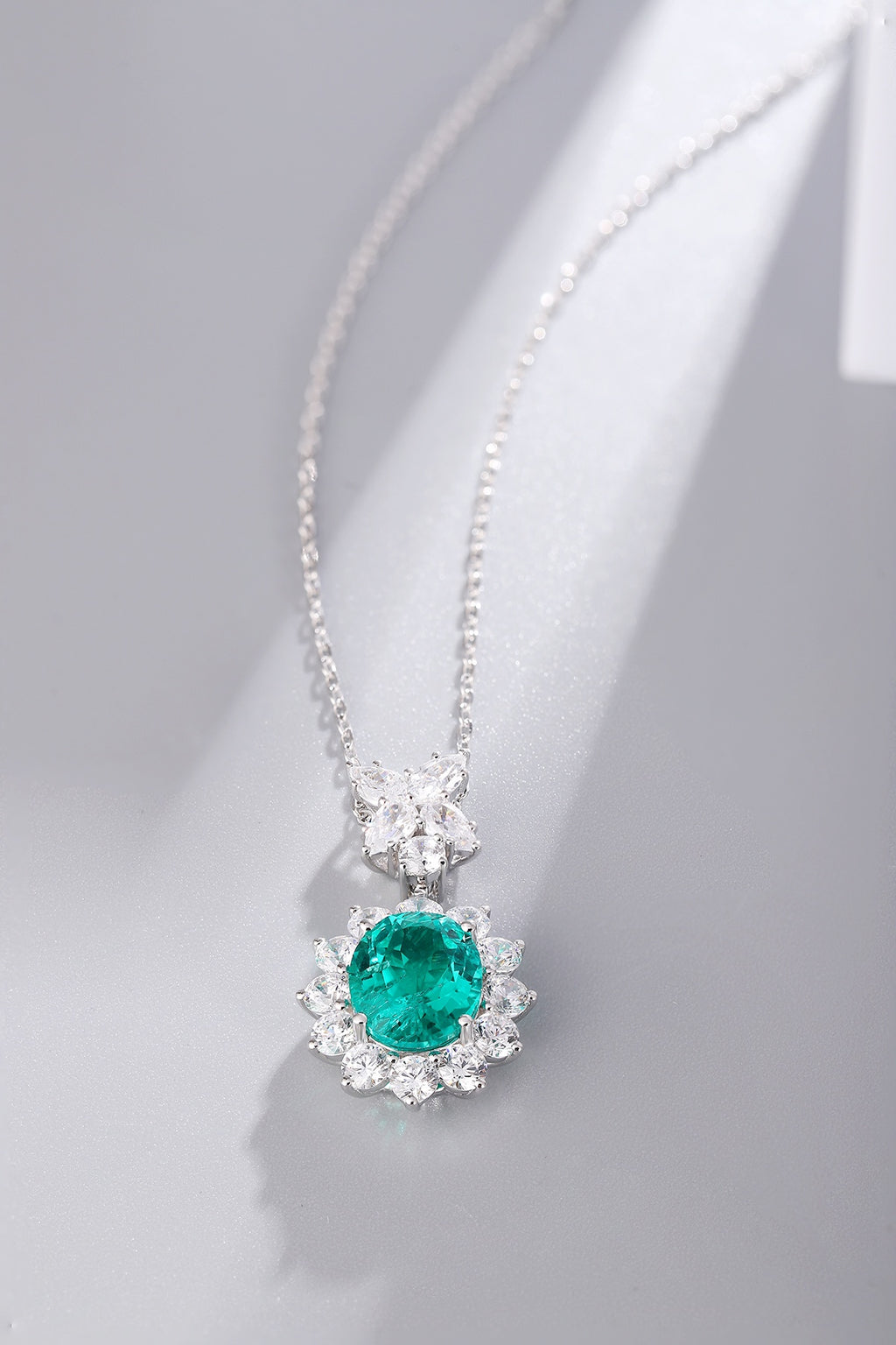 S925 silver necklace with a unique design. Oval emerald with diamond accents, deep green, graceful shape.