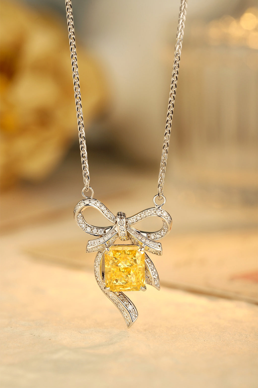 This S925 silver necklace features a bow - shaped design. Yellow lab - grown diamond set, sunny color, charming form.