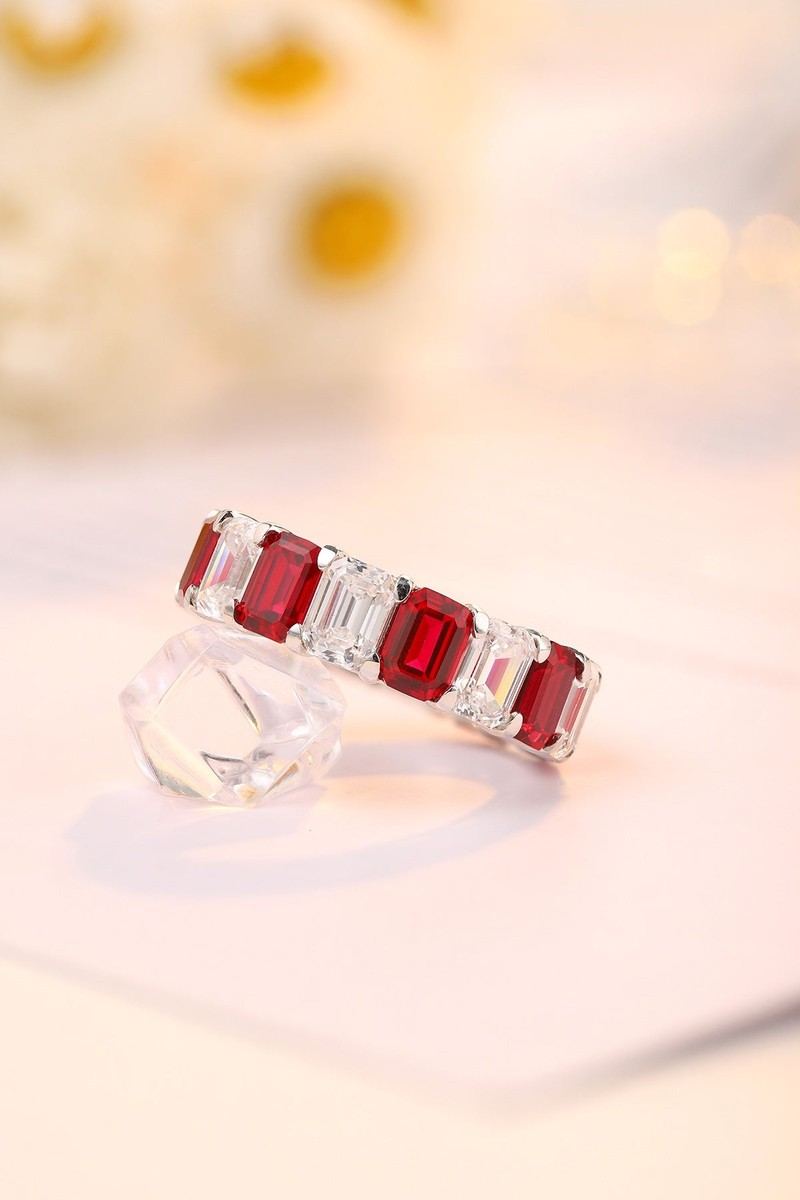 This S925 silver ring has a fine structure. Red lab-grown rubies and diamonds in row, classic circular form.