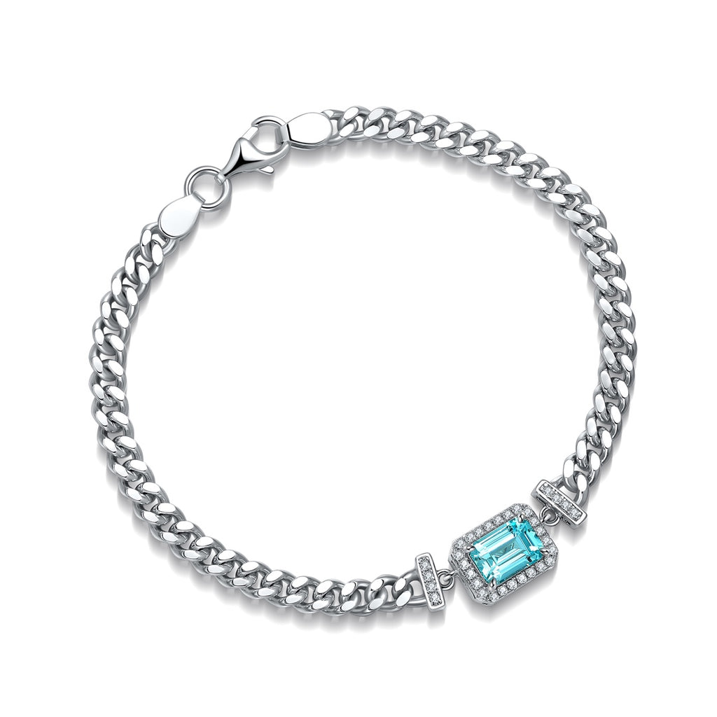 S925 silver bracelet, with a secure lobster - claw clasp. Features a rectangular lab - grown Paraíba tourmaline, vibrant blu