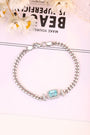 The S925 silver bracelet features a reliable clasp. Rectangular blue lab - grown Paraíba tourmaline, on chain, charming shap