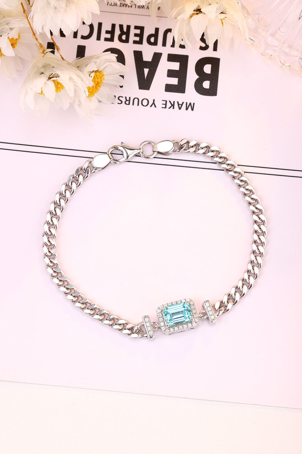 The S925 silver bracelet features a reliable clasp. Rectangular blue lab - grown Paraíba tourmaline, on chain, charming shap