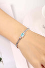 S925 silver bracelet, clasp sturdy. Showcases a rectangular lab - grown Paraíba gem with bright blue color, chain - shaped d
