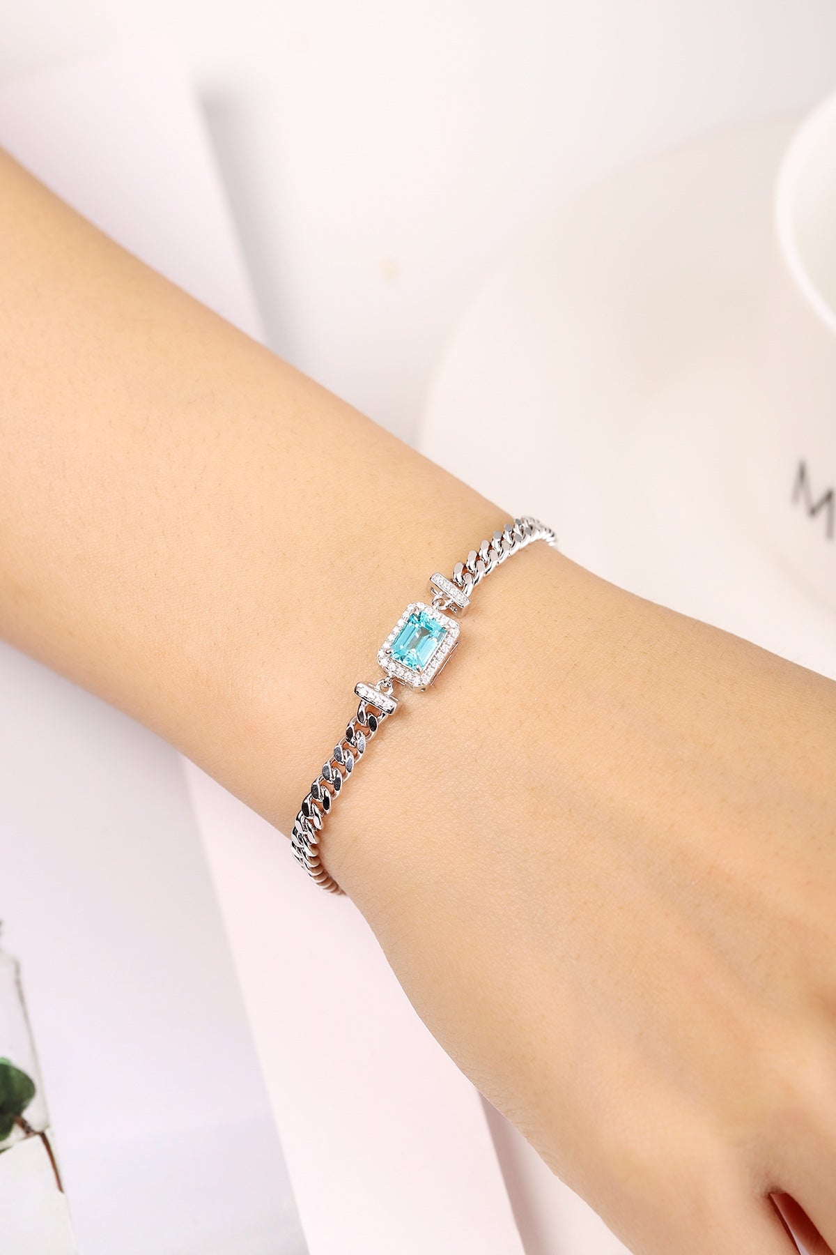 S925 silver bracelet, clasp sturdy. Showcases a rectangular lab - grown Paraíba gem with bright blue color, chain - shaped d