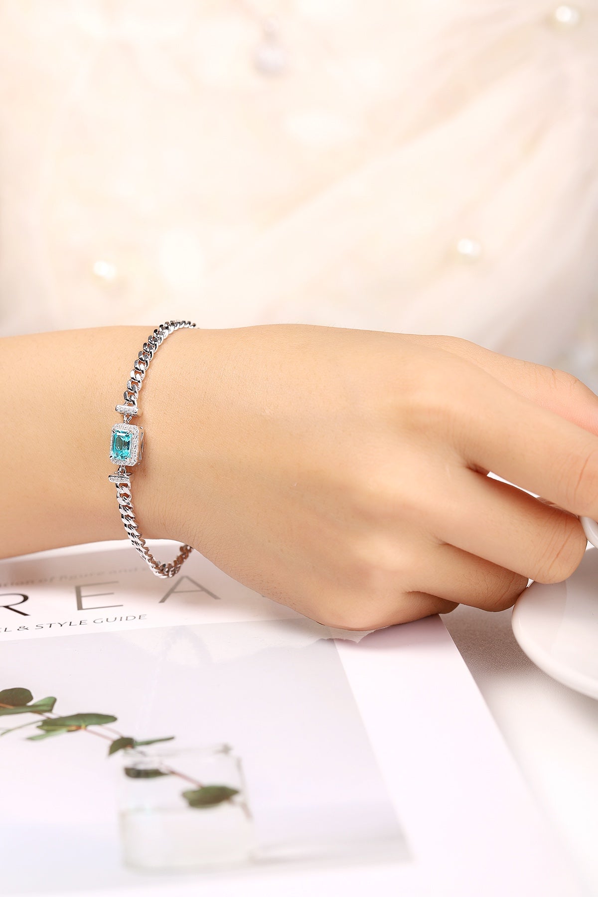 This S925 silver bracelet has a well - made clasp. Rectangular Paraíba tourmaline with blue hue, set on chain, elegant shape