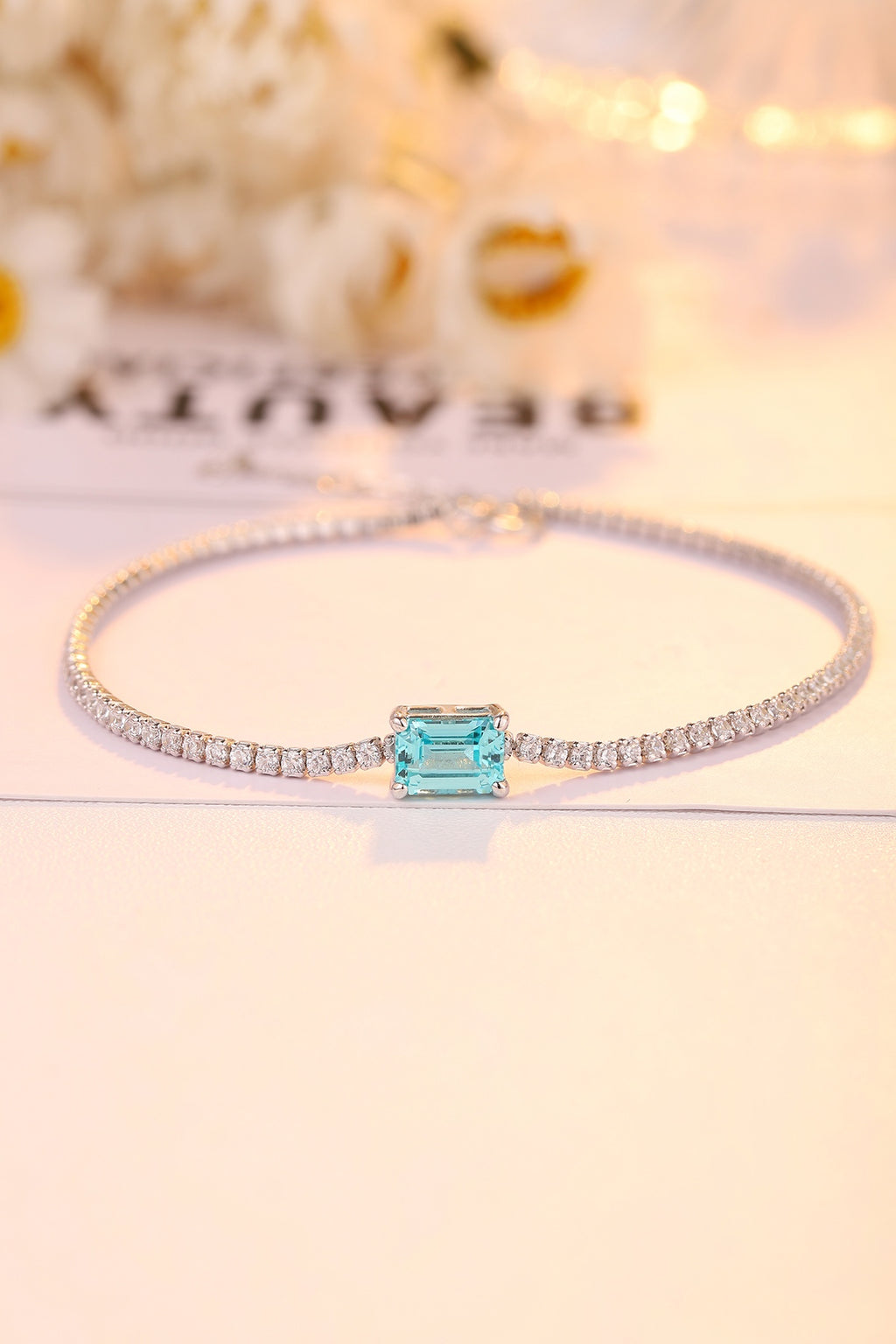 This S925 silver bracelet has a practical clasp. Rectangular blue diamond set among diamonds, linear design, elegant shape.