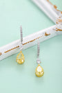 These S925 silver earrings have a fine clasp. Clear and yellow cubic zirconia in teardrop form, elegant design.