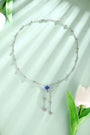S925 silver pendant necklace with reliable clasp. Shows a flower-shaped deep-blue gem with dangling diamonds, stylish.