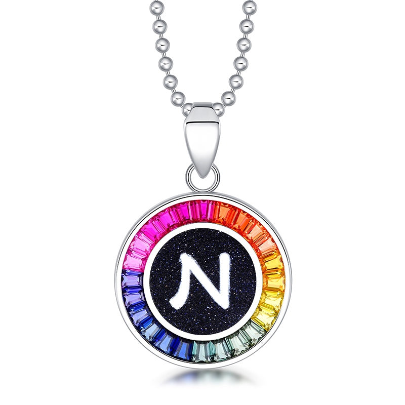 Petite S925 silver necklace, ball - chain design. Features a round "N" pendant, multi - colored with lab - grown sapphires.