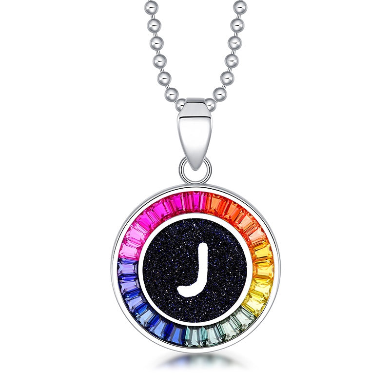 Petite S925 silver necklace, ball - chain design. Features a round "J" pendant, multi - colored with lab - grown sapphires.