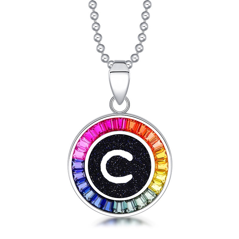 Petite S925 silver necklace, ball - chain design. Features a round "C" pendant, multi - colored with lab - grown sapphires.