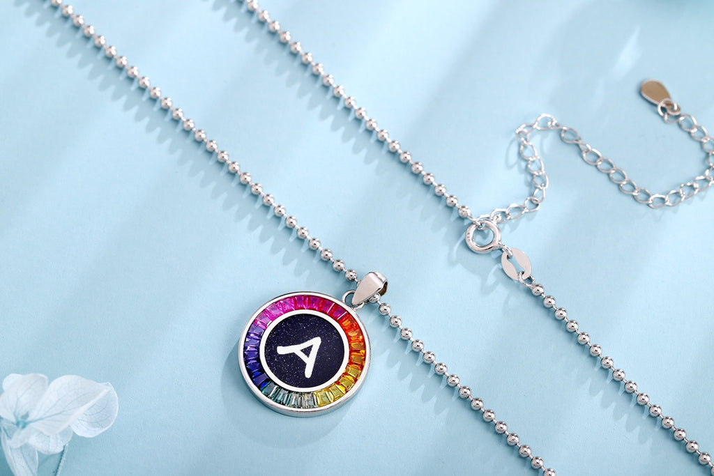 S925 silver necklace in petite size, chain design elegant. Shows various colors, round shape with alphabet.