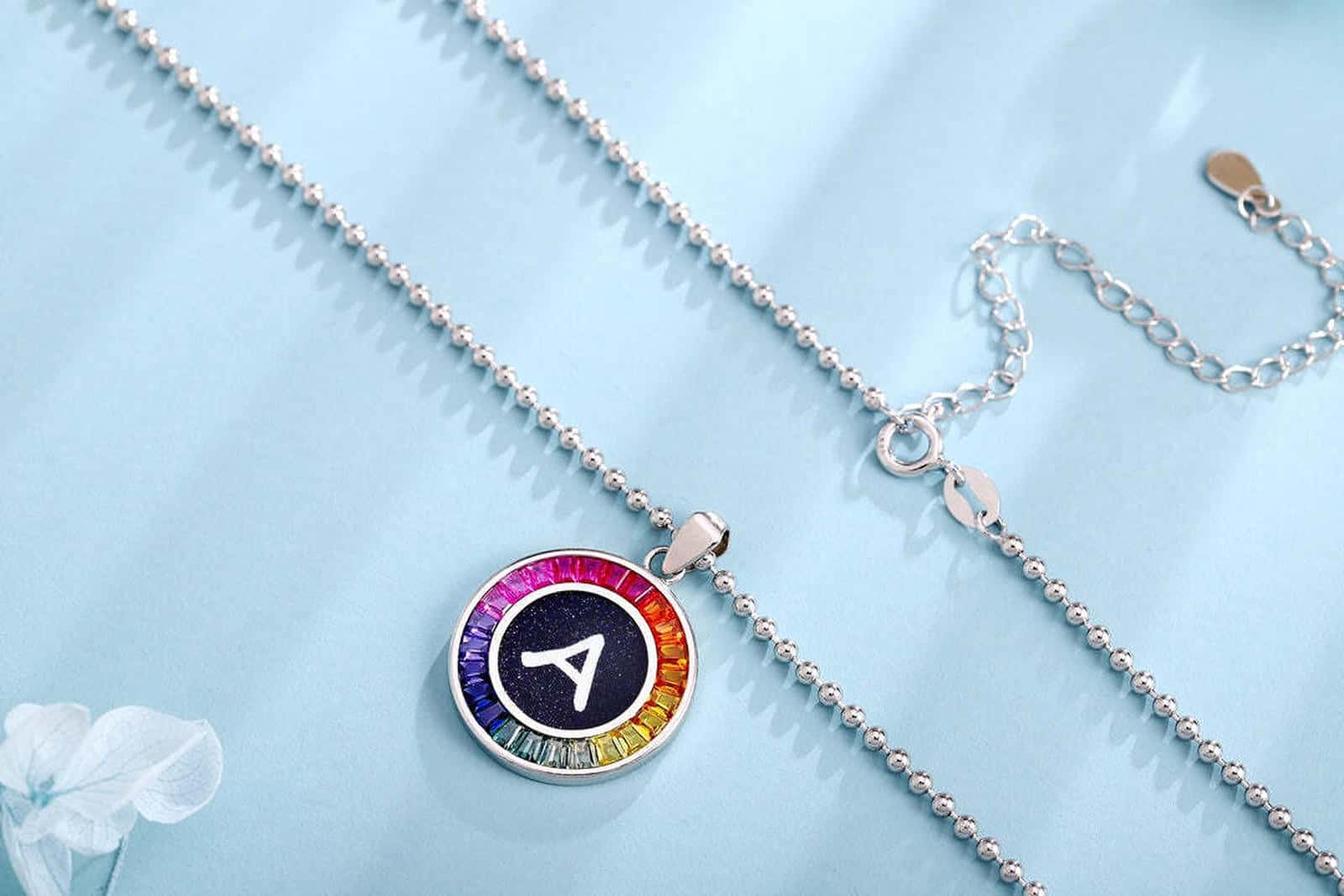 S925 silver necklace in petite size, chain design elegant. Shows various colors, round shape with alphabet.