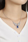 The silver chain (S925) has a delicate clasp, the wing-shaped diamond design with a teardrop blue stone exudes elegance.