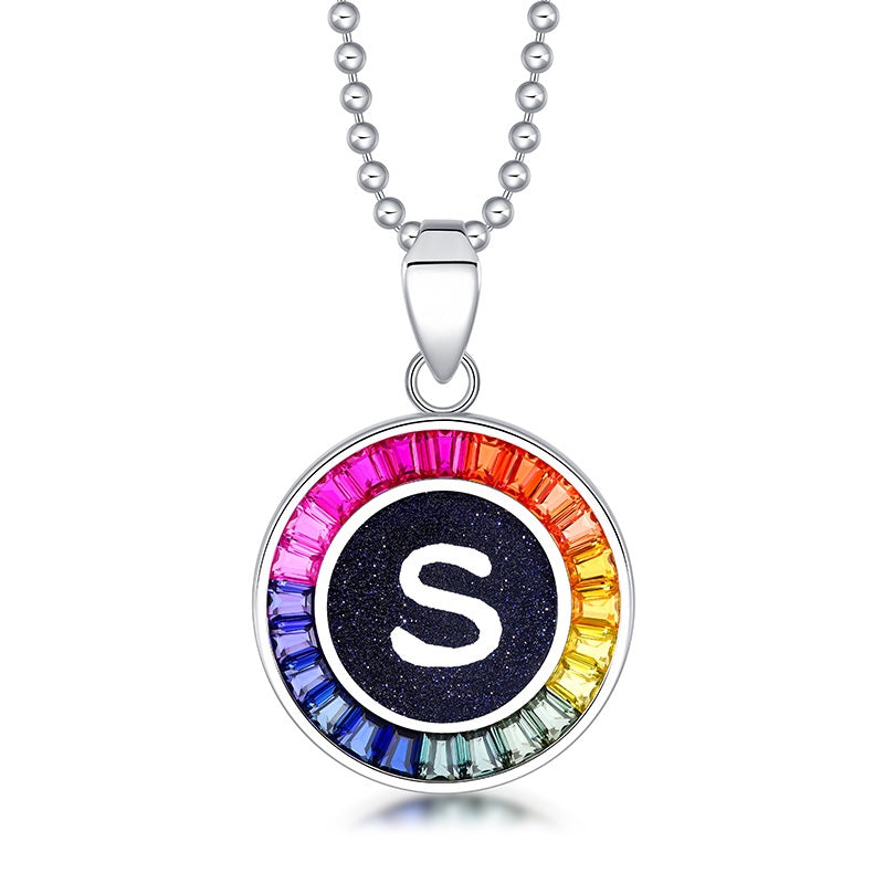 Petite S925 silver necklace, ball - chain design. Features a round "S" pendant, multi - colored with lab - grown sapphires.