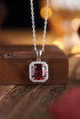 This S925 silver necklace has a lobster clasp. Features a square deep-red garnet surrounded by small diamonds, elegant design