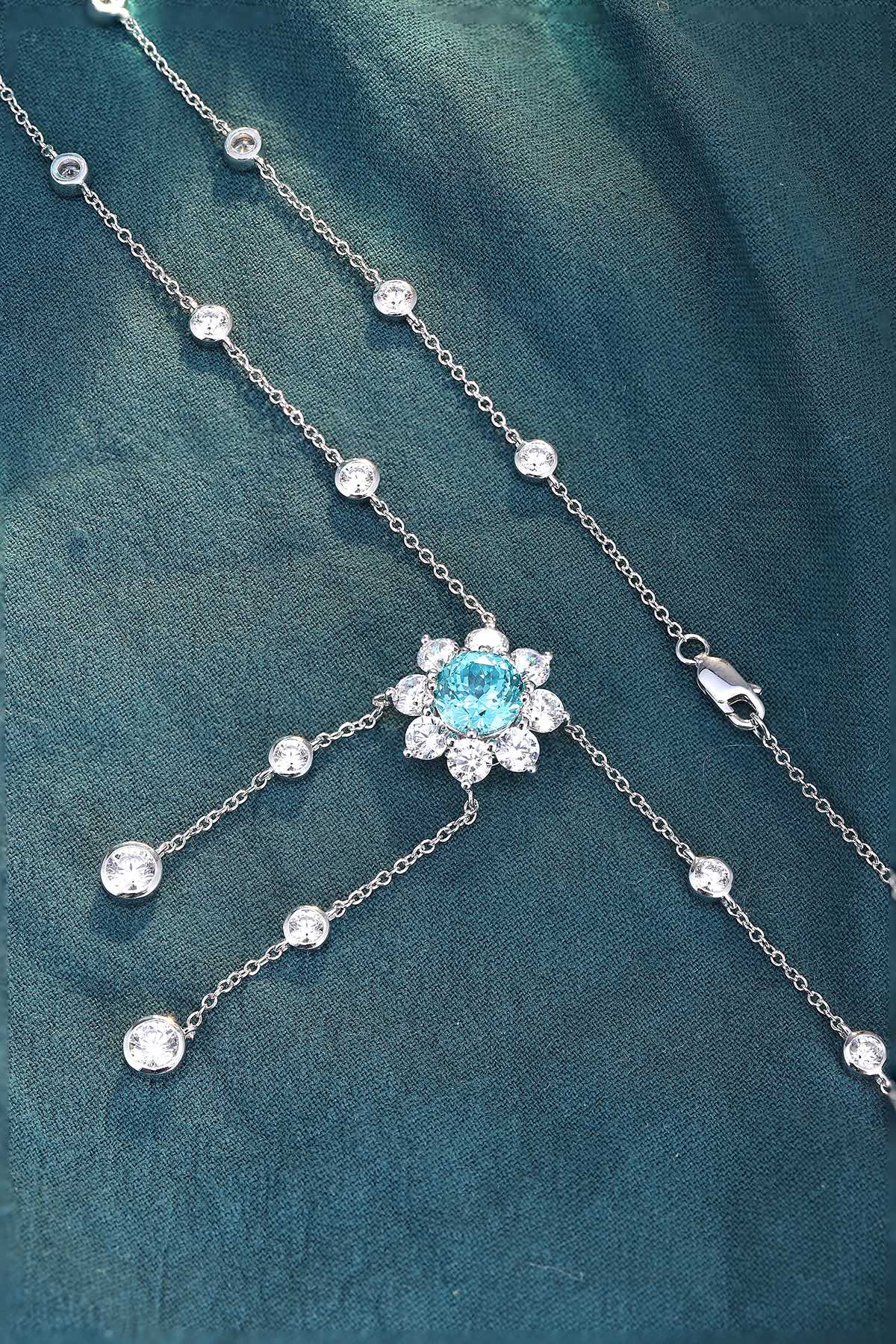 This S925 silver necklace has a secure clasp. Features a floral-designed light blue gemstone with diamond accents, charming s