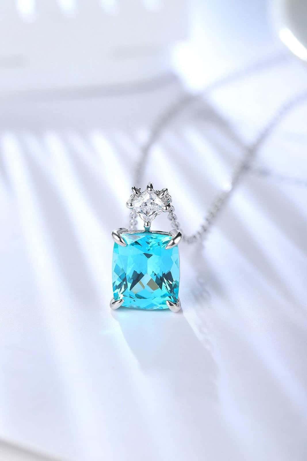 S925 silver necklace with fine clasp. Shows a square bright blue lab-grown Paraíba tourmaline and a small diamond, nice.