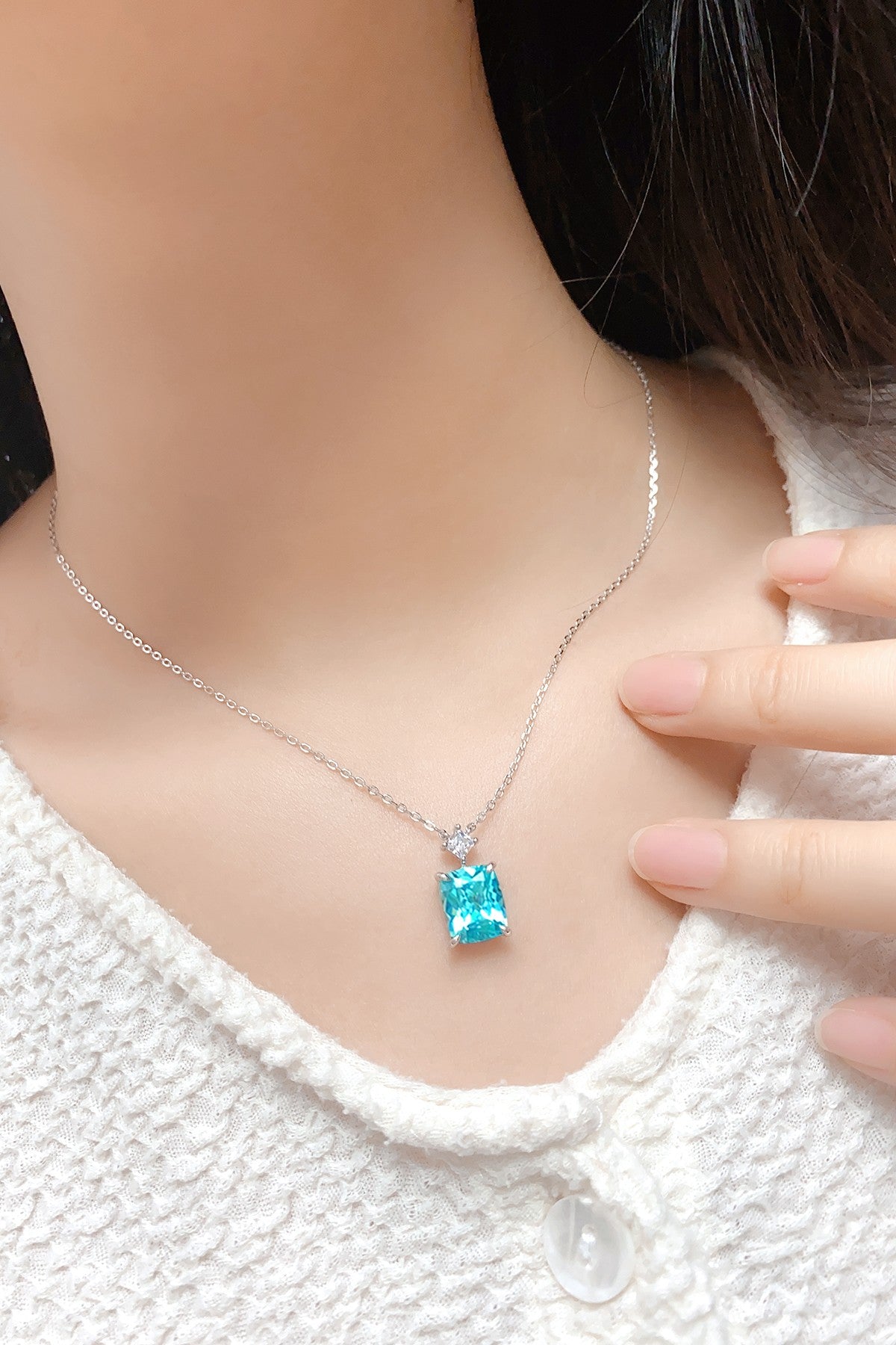 This S925 silver necklace has a secure clasp design. Features a square vivid blue lab-grown gem with a diamond accent, elegan