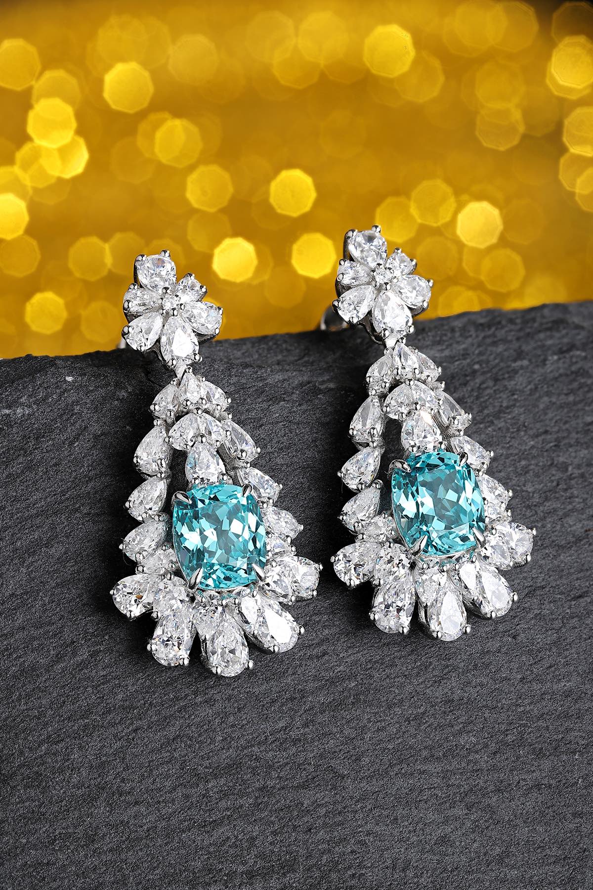 These S925 silver earrings have a fine clasp. Blue - green gem in floral setting, sparkling color, elegant teardrop form.