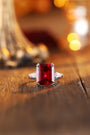 The open - end S925 silver ring is inlaid with a square lab - grown red gemstone using claw - setting technique. The red gems