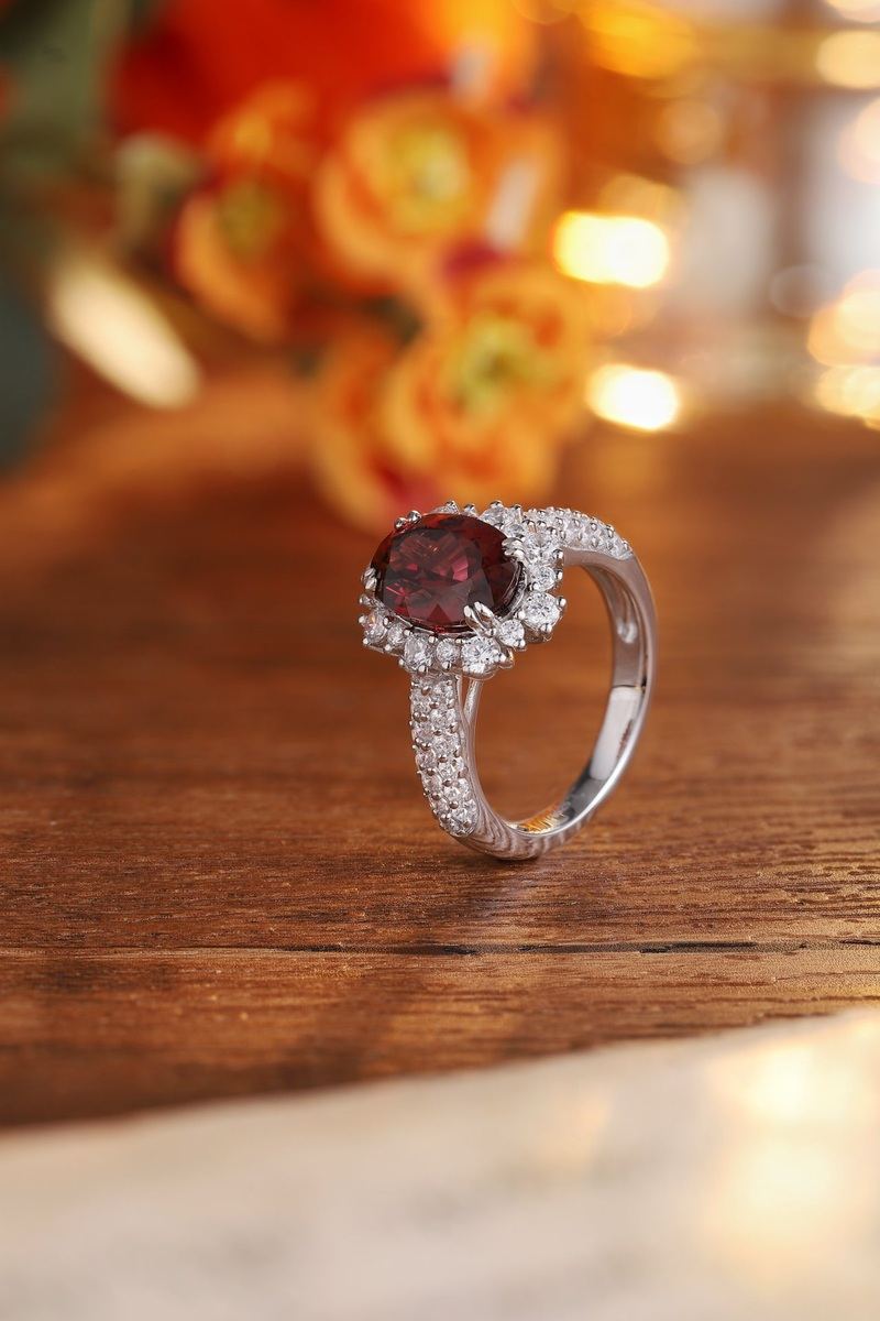 This S925 silver ring has a practical opening. Deep - red natural garnet encircled by small diamonds, oval form, nice.