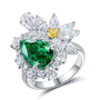 This S925 silver ring has an open design, featuring a lab-grown emerald and diamonds, with bright colors and an elegant look.