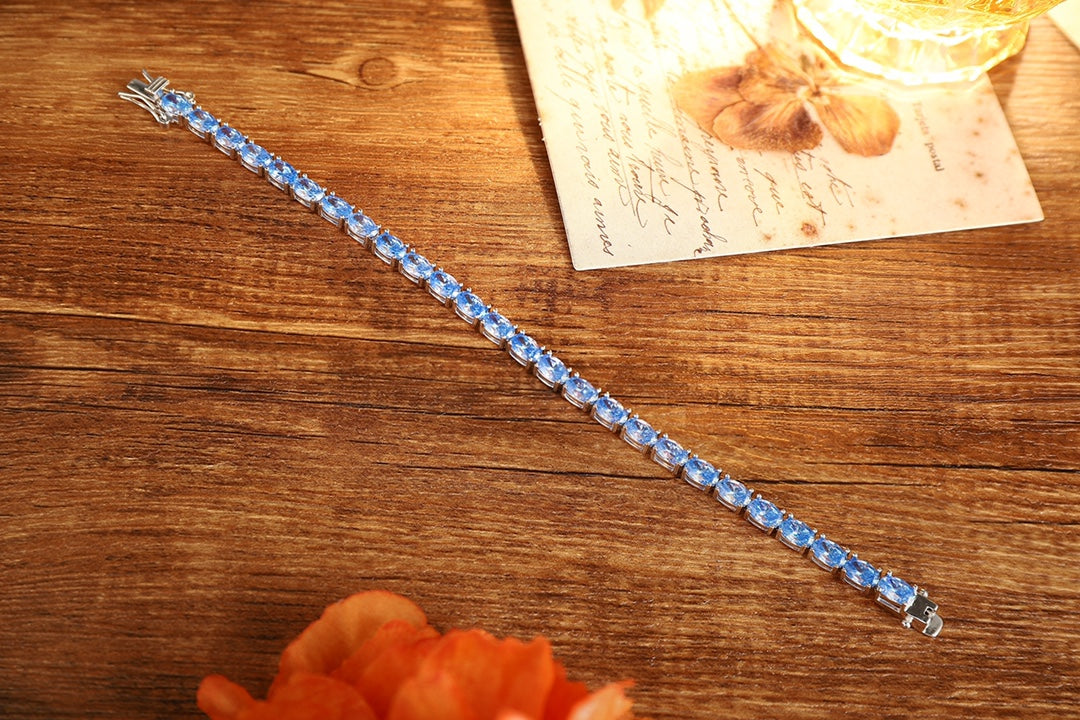 This S925 silver bracelet has blue gems, oval shape, and a practical clasp, pretty.