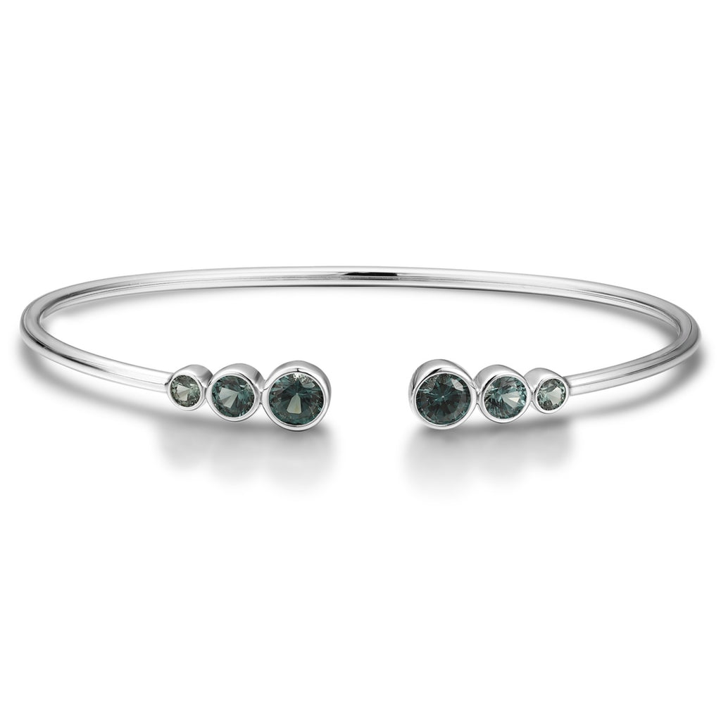 Open cuff bracelet of S925 silver with grey - green sapphires, round gems, open design for comfortable fit.
