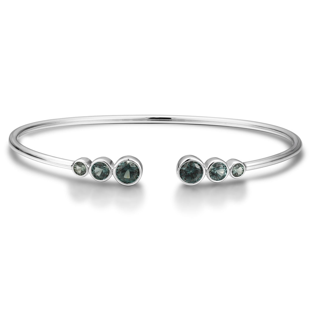 Open cuff bracelet of S925 silver with grey - green sapphires, round gems, open design for comfortable fit.