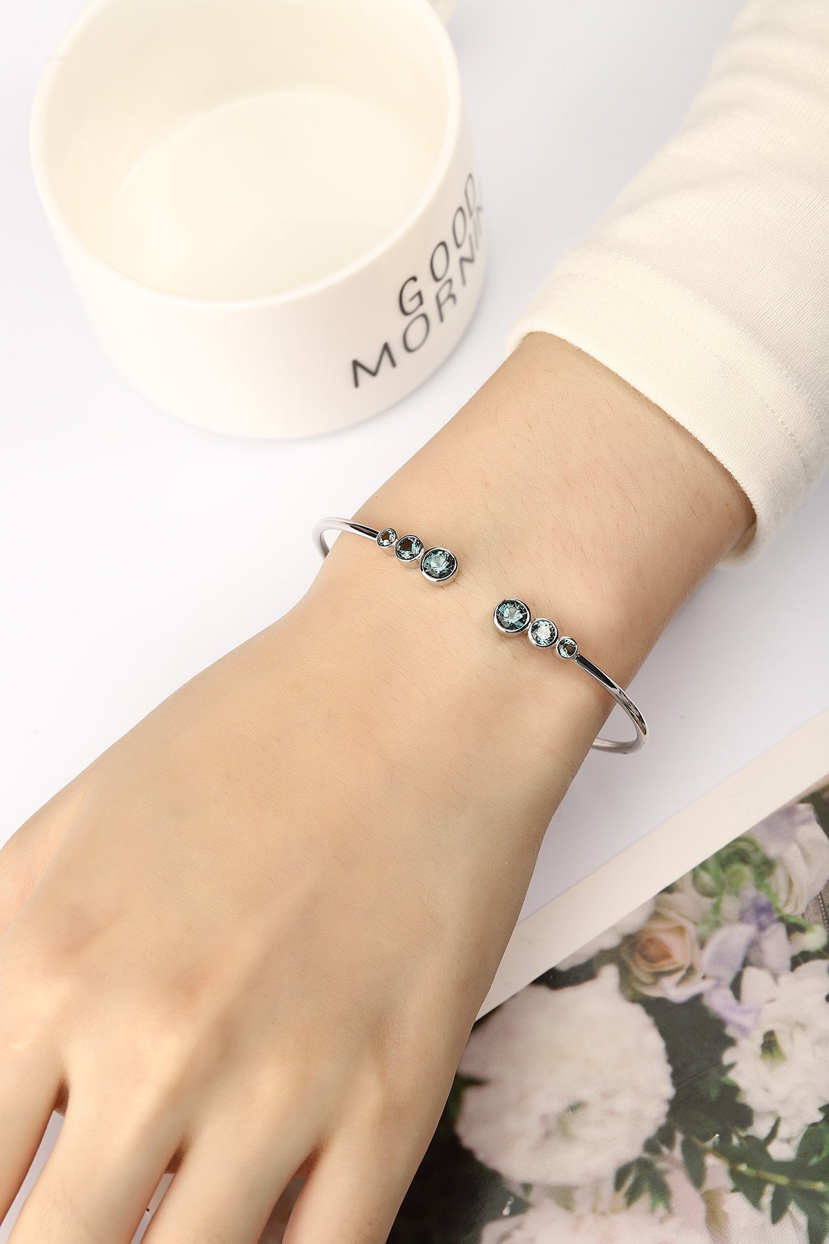 Material is S925 silver, grey - green gems are unique, round shape, open - style design fits wrist well.