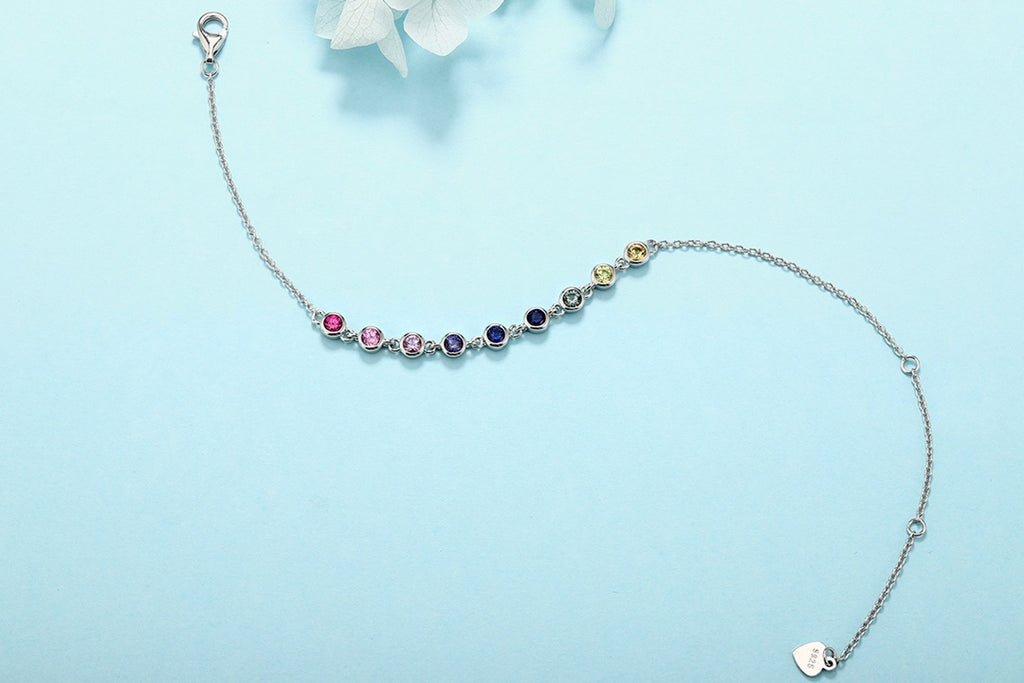 This S925 silver bracelet has multi - hued sapphires, round shape, clasp and extender, elegant.