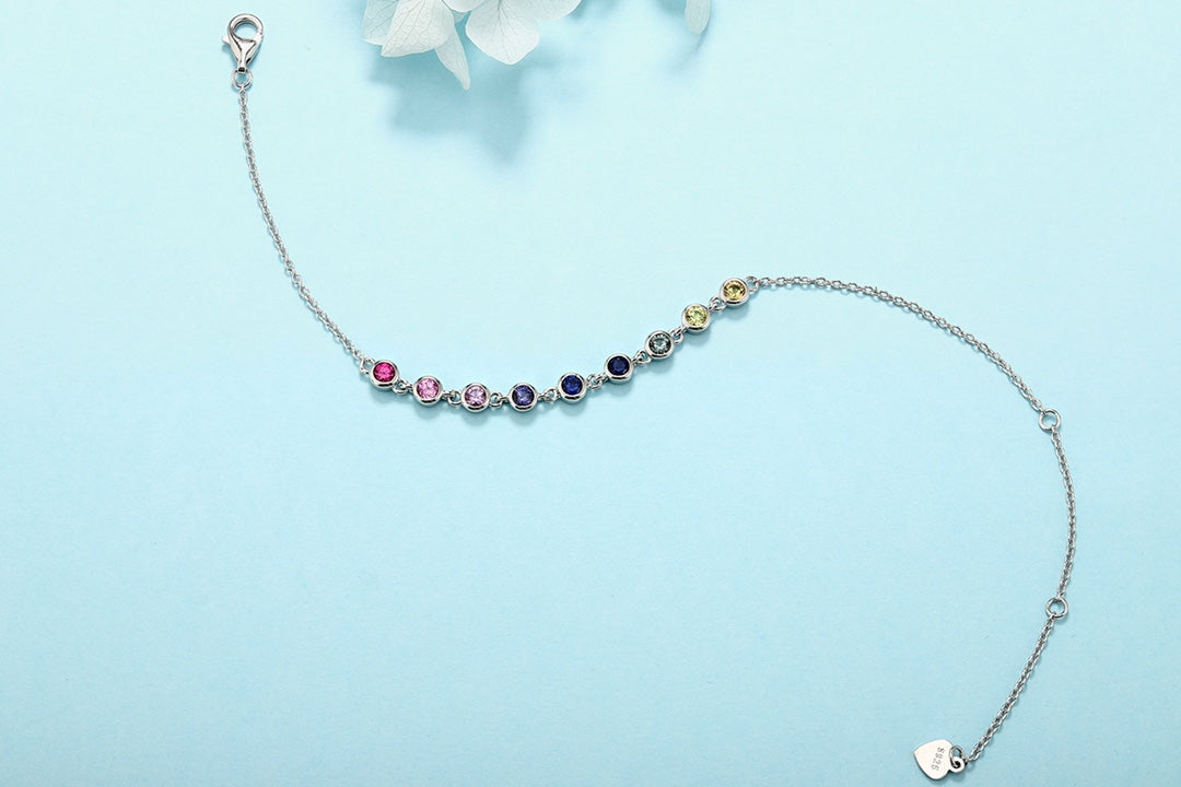 This S925 silver bracelet has multi - hued sapphires, round shape, clasp and extender, elegant.