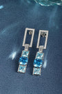 These S925 silver earrings have a fine clasp. Diamond-encrusted rectangle and square blue gems, modern geometric design.