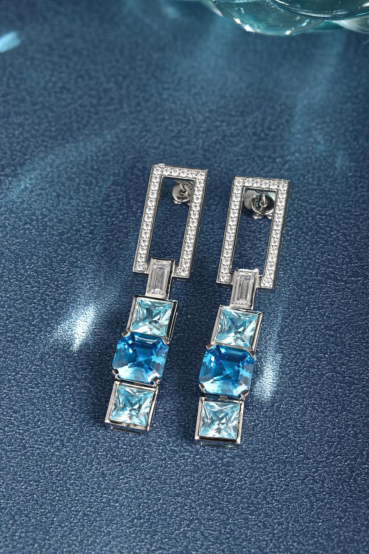 These S925 silver earrings have a fine clasp. Diamond-encrusted rectangle and square blue gems, modern geometric design.