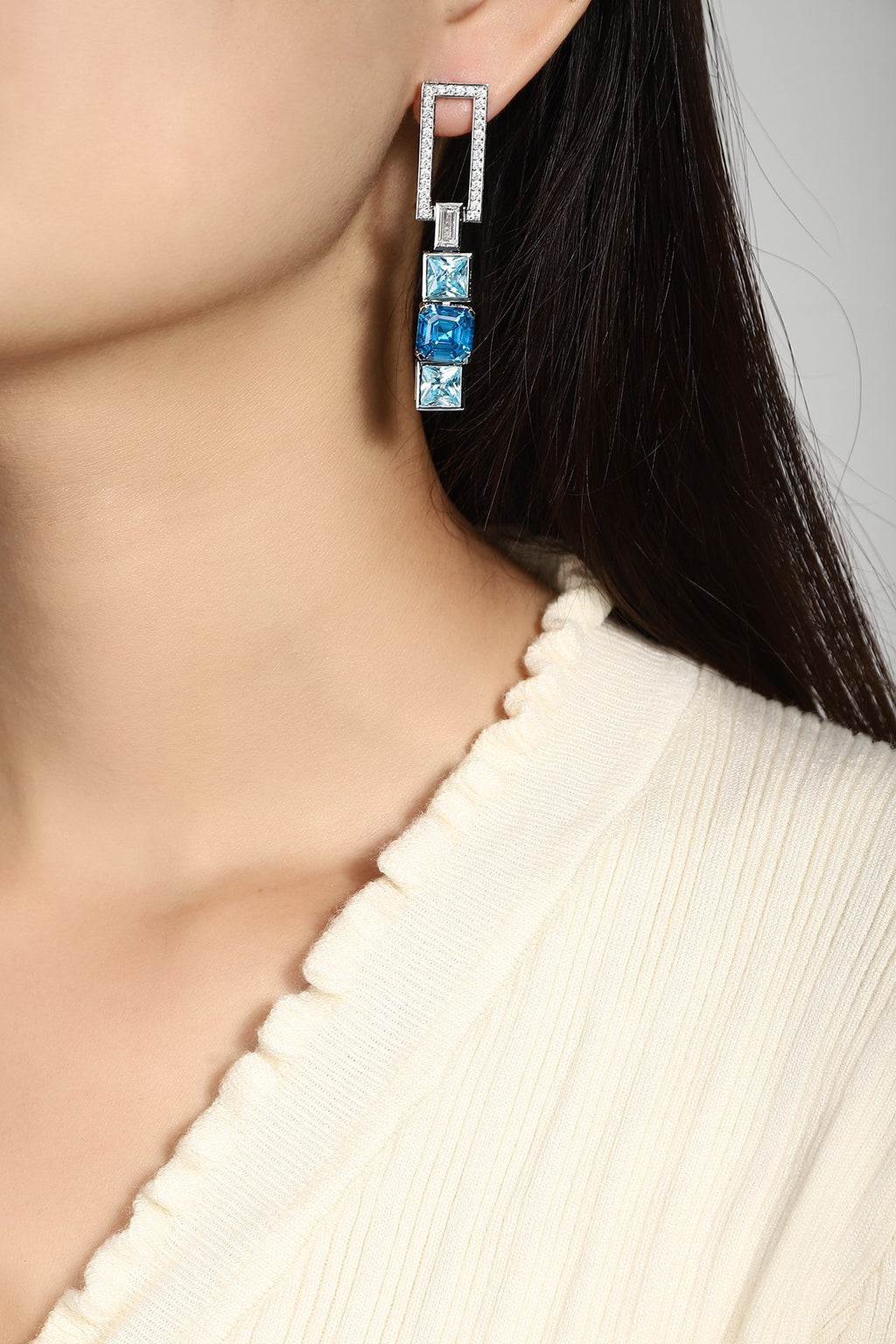 The S925 silver earrings feature reliable clasp. Rectangular diamond part and square blue gems, stylish geometric form.