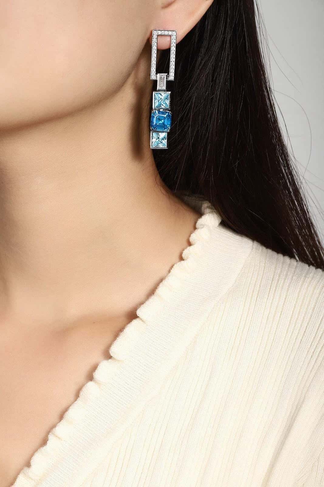 The S925 silver earrings feature reliable clasp. Rectangular diamond part and square blue gems, stylish geometric form.