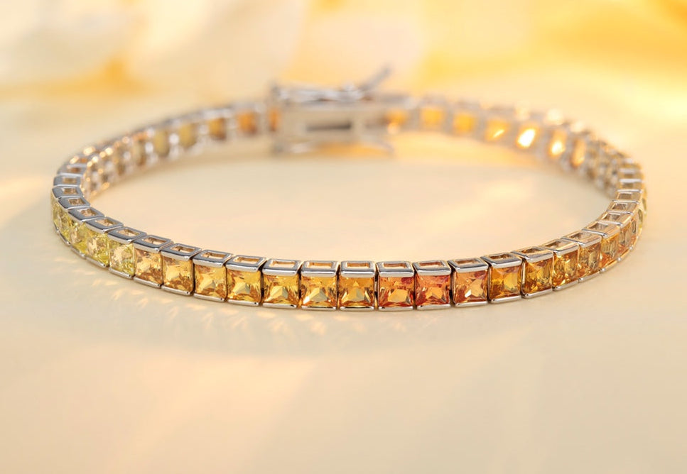 The S925 silver bracelet features an exquisite clasp design. Lab-grown colored sapphires show warm tones. Three sizes cater t