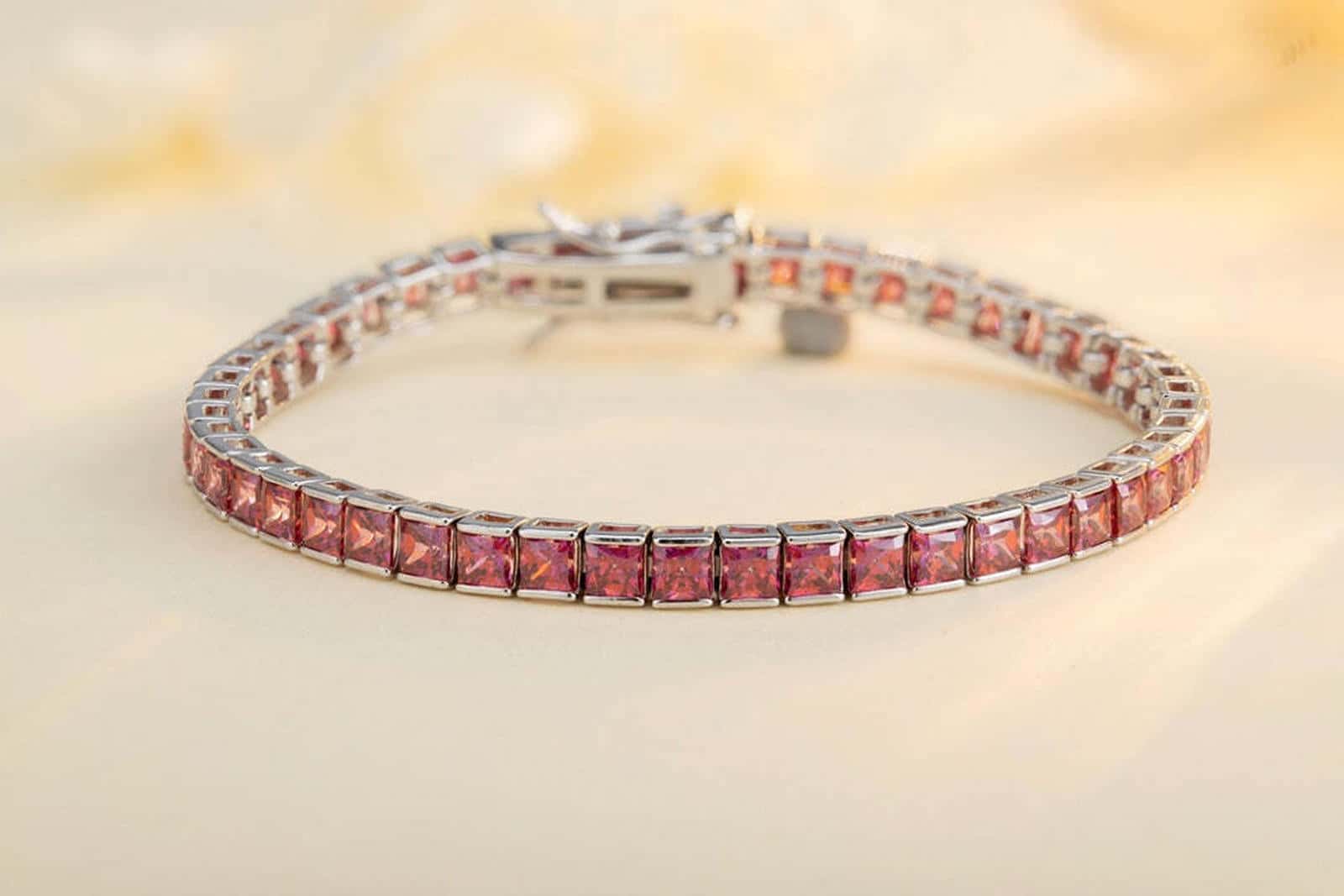 The S925 silver bracelet features a secure and easy-to-use clasp. Embedded with pink lab-grown colored sapphires in a row, it