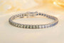 The silver bracelet (925 silver) with a simple clasp, paved with square colored sapphires, in a blue-green gradient, with a r