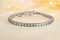 The silver bracelet (925 silver) with a simple clasp, paved with square colored sapphires, in a blue-green gradient, with a r