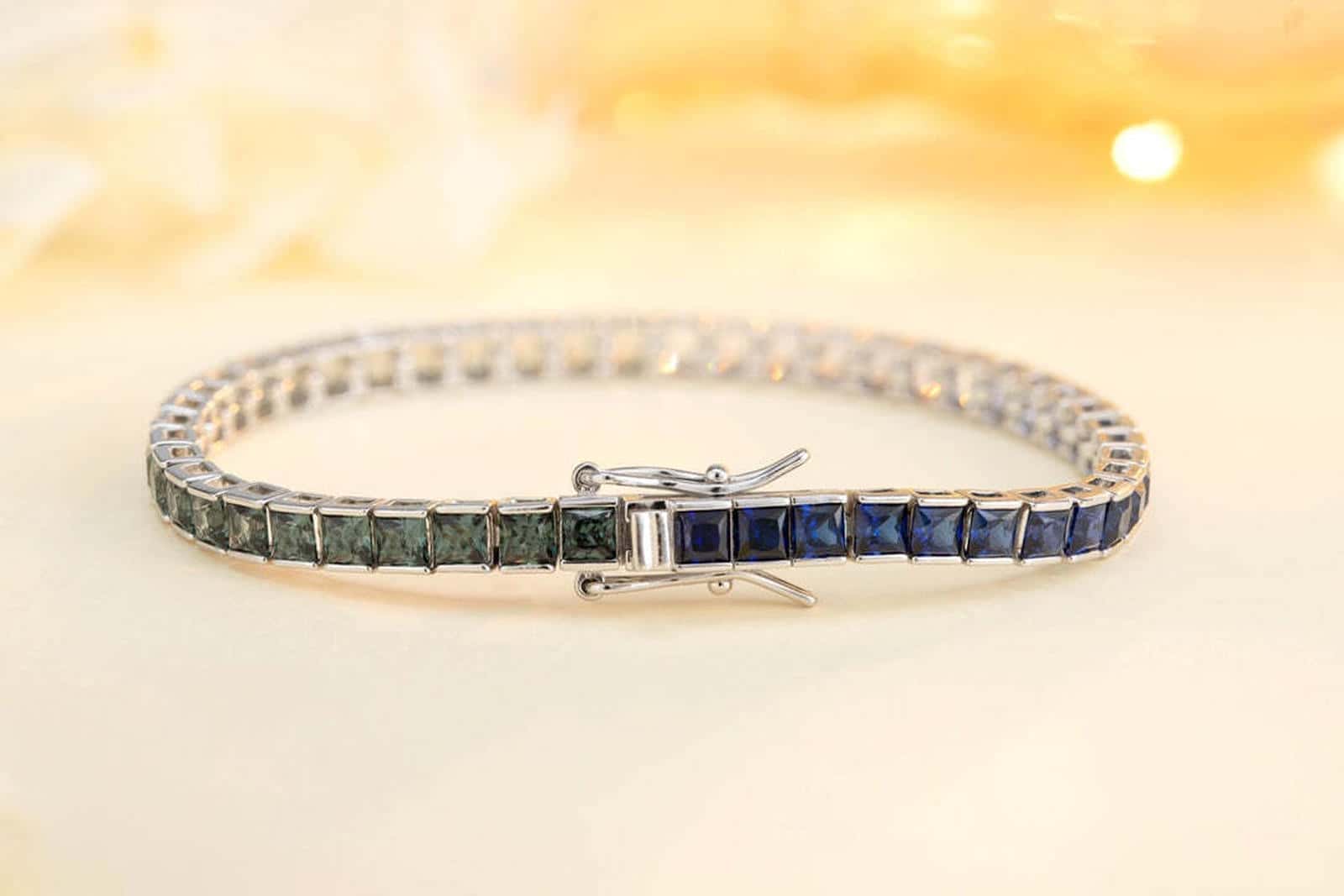 This silver jewelry (925 silver) has a delicate clasp design, connected square colored gems, with blue, green and other color