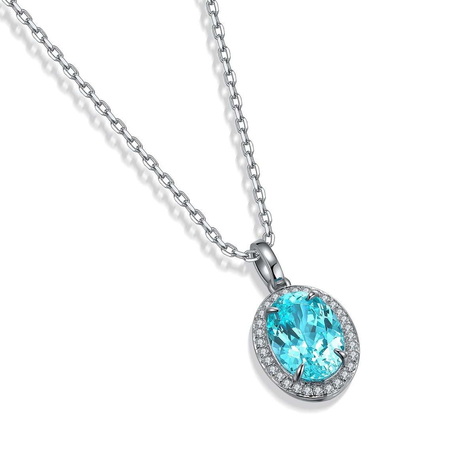 S925 silver necklace with secure clasp. Oval blue gem surrounded by diamonds, elegant shape.