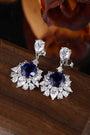 The stud earrings made of S925 silver have delicate and durable clasps. The lab-grown sapphires in deep royal blue are surrou