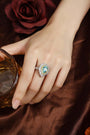 The S925 silver ring boasts a solid design. Shows a pear - shaped bright blue lab - grown gem with diamond and yellow diamond