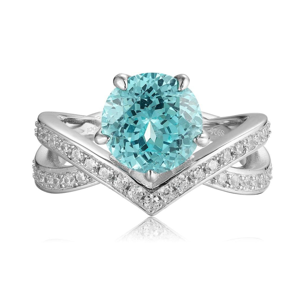 S925 silver ring with opening design. Cross - over band with pave diamonds, round lab - grown blue gem at center, elegant V -