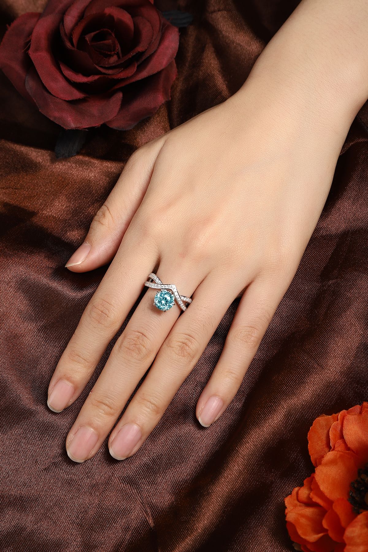 This S925 silver ring has an opening. V - shaped cross - over design with diamonds, round blue lab - grown gemstone, stylish.