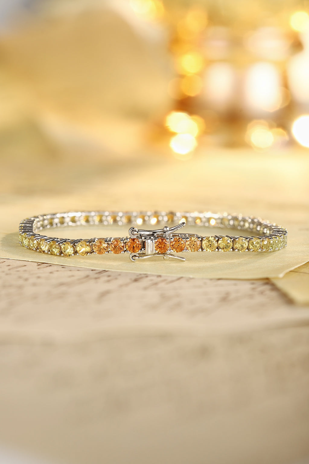 This bracelet is made of S925 silver with a delicate and durable clasp. The yellow-orange lab-grown colored sapphires are arr